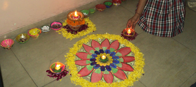 Beautiful Rangoli decorated with colours, flowers and light