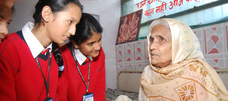 Young girls interacting with an older woman, trying to gain all from her wisdom